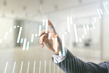 Poster - Man hand working with abstract virtual financial graph on blurred office background, forex and investment concept. Multiexposure