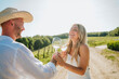 © Westend61 - Happy couple having fun with wine glass at winery