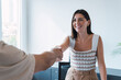 © Westend61 - Happy real estate agent shaking hands with client in office