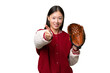 Young asian woman with baseball glove over isolated background shaking hands for closing a good deal