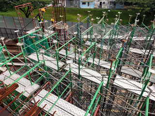 Wall Mural - 
JOHOR, MALAYSIA -JUNE 17, 2022: The construction site is in progress. Construction work is being carried out in stages. Construction workers are carrying out work under strict safety supervision.