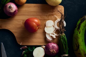 Wall Mural - Top view of a tomato on a wooden board with other vegetables