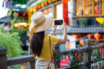 Sticker - Woman take photo on cellphone in Jiufen village of Taiwan