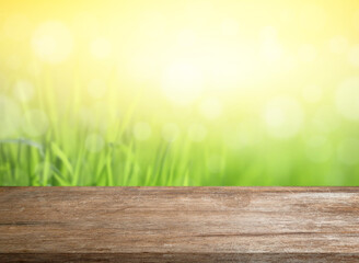 Poster - Wood table top and blur of fresh green bokeh with nature garden background. For product display and natural spring or summer concept. 