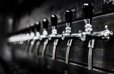 many beer taps in bar or pub. tap room