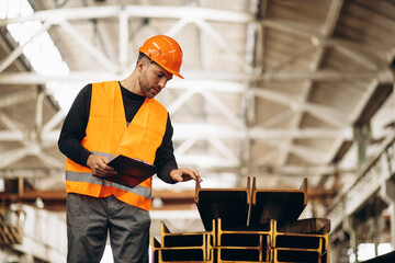 worker at the steel factory checking the material