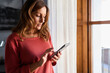 © ADDICTIVE STOCK - Mature woman sending a text message