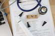 Medical documents, equipments and word ent collected with wooden cubes