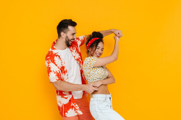 Multiracial happy couple dancing while making fun together