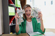 Happy excited woman holding fan of money