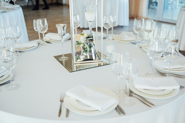 Wall Mural - Luxurious restaurant. Luxurious interior, white tables, serving dishes and glasses for guests