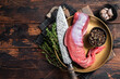 Raw beef veal tenderloin, fresh meat for fillet mignon steaks with herbs. Wooden background. Top view. Copy space