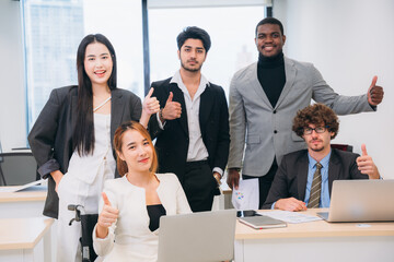 People in business are laughing and giving each other high-fives after a job well done.