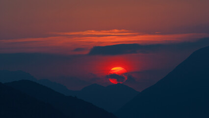 Wall Mural - Sun setting over the San Gabriel Mountains in Los Angeles County, California. Shown on October, 2022.