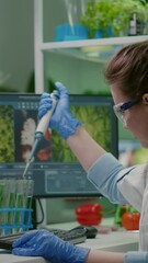 Wall Mural - vertical video: biologist scientist putting solution liquid in test tube using micropipette analyzin