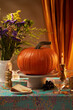 Pumpkin over a decorated table and candles