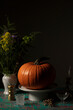 Pumpkin over a decorated table and dark ambient