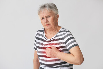 Sticker - Senior woman having heart attack on grey background