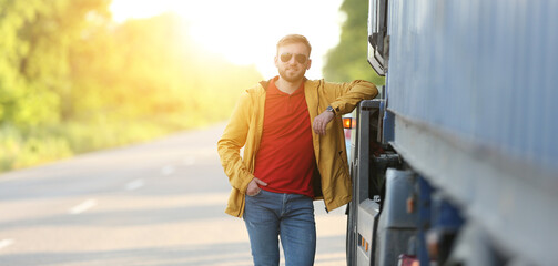 Portrait of male driver near big truck outdoors