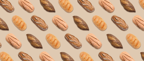 Many loaves of bread on beige background. Banner for design