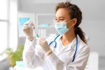 Poster - Female doctor in medical mask with syringe and ampule at hospital