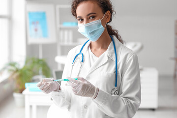 Wall Mural - Female doctor in medical mask with syringe and ampule at hospital