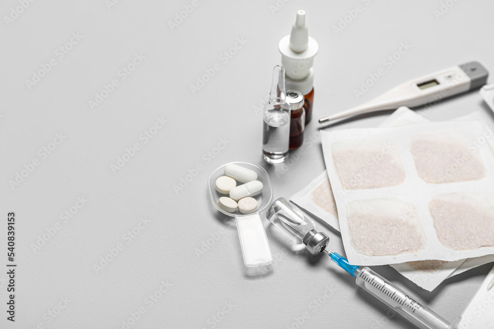 Mustard plasters with medicines on grey background