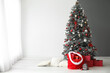 Beautiful Christmas tree and Santa bag with gifts in room