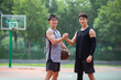 © Blue Jean Images - Happy young men playing basketball outdoors