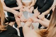 © panophotograph - Partnership and unity concept: unrecognizable women in sportswear holding wrists of each other, forming circle. Group of happy young womans holding hands. Side view on human hands. Selective focus