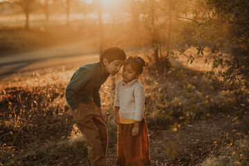 Brother and sister outdoors at a trail 