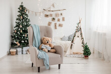 New Year 2023 Scandinavian Interior. Children's Tent Decorated With Spruce Branches, Cozy Armchair And Christmas Tree Decorated In Beige Natural Colors. Advent Calendar On The Wall. Selective Focus