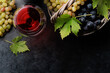 Red wine glass and grape in basket