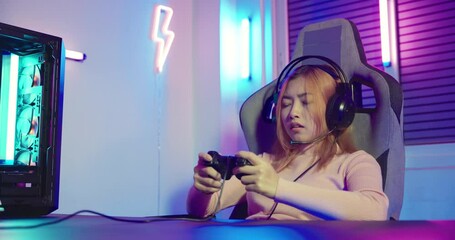 Canvas Print - You win. Gamer using joystick controller plays online video game with computer neon lights she winning, woman wear gaming headphones playing live stream esports games console at home celebrating win