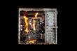 © Torkhov - a burning system unit from a computer from a short circuit and a power surge on a black isolated background