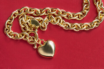 Poster - Gold necklace on red background