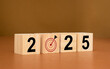 Business planning in 2025. Wooden cubes with the letters 2025 on a table with a brown background