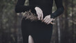 © junky_jess - Beautiful faceless woman in black tight dress with a bouquet of dried flowers in hands in the black forest, selective focus.