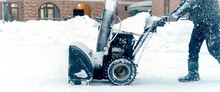 A Snow Plow Removes Snow On The Playground