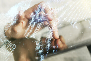 Multi exposure of abstract creative digital world map and finger presses on a digital tablet on background, research and analytics concept