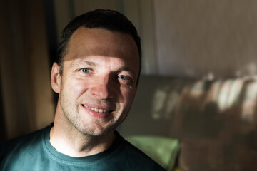 Wall Mural - Close up face portrait of smiling young adult man