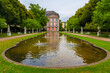 Picturesque view of the eastern part of the Palastgarten, the garden of the Electoral Palace in Trier, Germany. The pond is surrounded by white statues designed by Ferdinand Tietz.