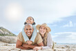 © J Maas/peopleimages.com - Family, diversity and lying at beach, smile or portrait to relax, together and sun by sea for happiness. Woman, black man and child on vacation, holiday or travel to ocean, family and happy in summer