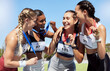 © J Maas/peopleimages.com - Runner, women and group with medal, winner and smile for sports, field and global competition in sun. Athlete, woman and diversity after podium, winning and celebration for marathon, stadium or park