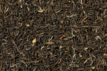 Wall Mural -  Dried Chun Hao Jasmin tea leaves, a high quality jasmin tea from the province of Fujian close up as background