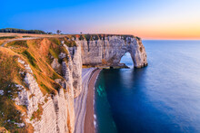 Normandy, France. Etretat Village Cliffs With The Manneporte Arch And The Valaine Beach.
