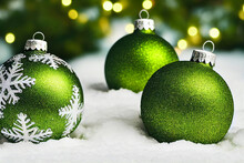 3d Illustration Of A Shiny Green Christmas Ornament In The Snow. Christmas