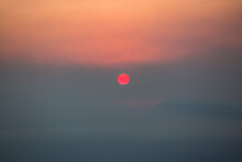 Sun Rising Through Smoke And Fog