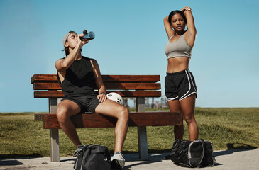 Poster - Man, woman and fitness break for stretching, drinking water or muscle recovery after training, exercise and workout. Soccer players, sports friends or football players in warmup in nature garden park