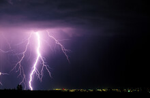A Large Lighting Bolt Lights Up The Sky As It Strikes Near Fort Collins Colorado.
